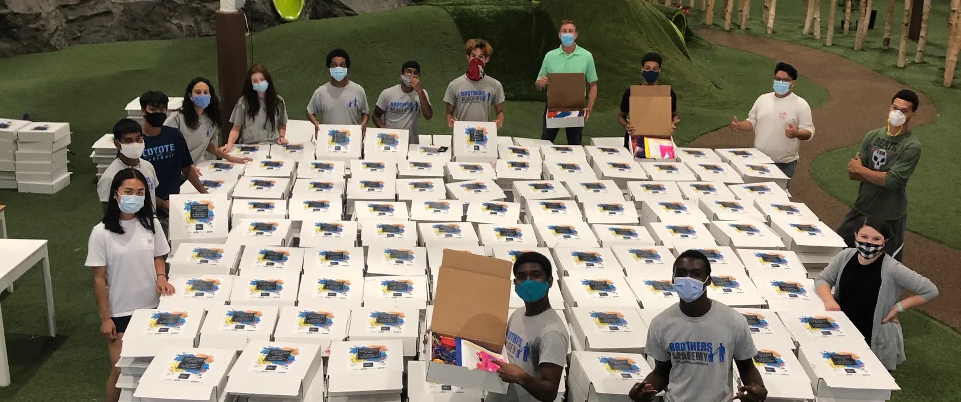 Volunteers preparing food boxes for the community