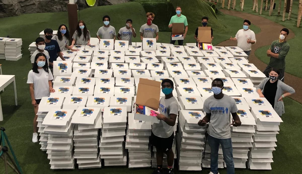 Volunteers preparing food boxes for the community